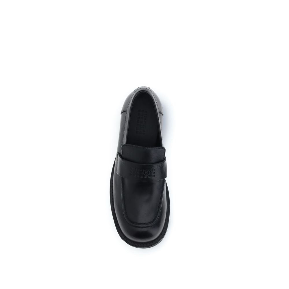 Flat Loafer Slip-On Shoes by MM6 for men in bos taurus calf leather black showcases a impeccable silhouette as Men's Bos Taurus Calf Leather Flat Loafer Slip-On Shoes, artfully designed with a impeccable flat and refined round toe style for a impeccable finish.