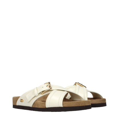 Clogs Slippers by Valentino Garavani for women in leather beige presents a effortless silhouette, showcasing the elegant Women's Leather Clogs Slippers design with its unique and sophisticated .