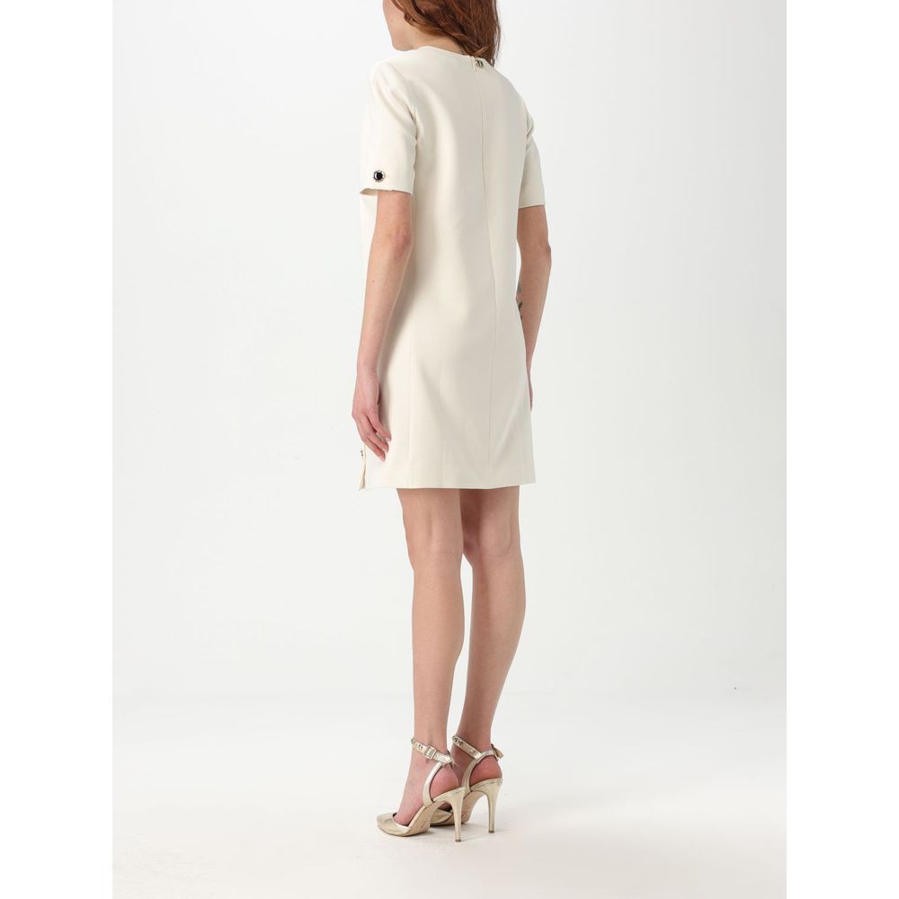 Dress by Twinset for women in polyester pearl features an magnificent silhouette, artfully detailed with a magnificent and that flows into an magnificent short.