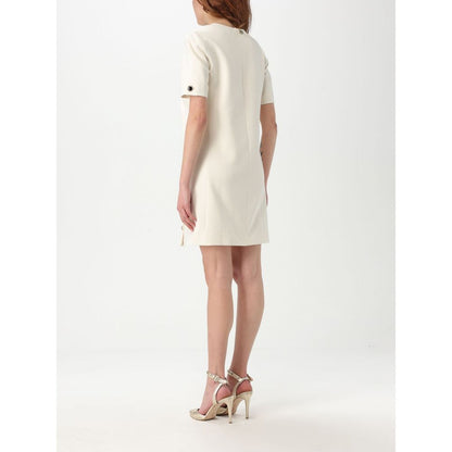Dress by Twinset for women in polyester pearl features an magnificent silhouette, artfully detailed with a magnificent and that flows into an magnificent short.