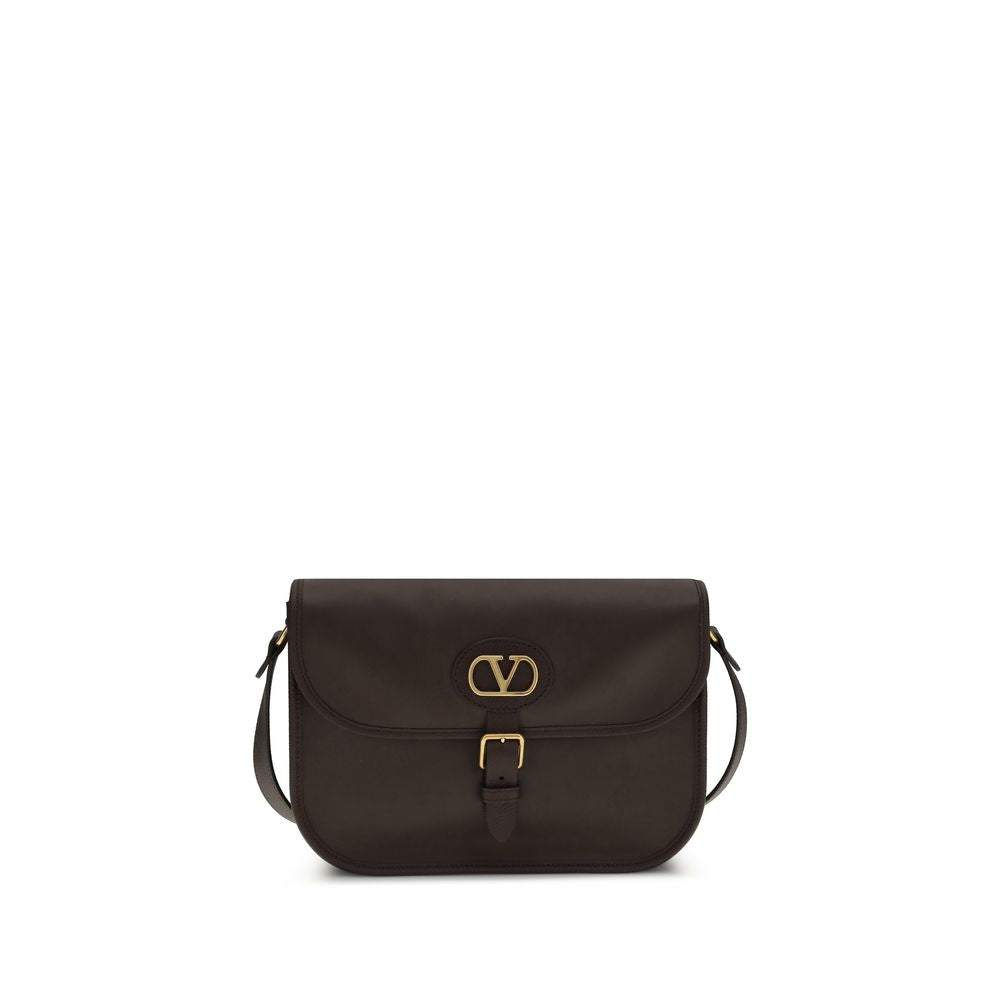 Shoulder Flap Bag by Valentino Garavani for men in bos taurus suede calfskin leather brown features a effortless sophistication silhouette, secured by a flap, magnetic & button with ample cardholder and versatile shoulder-strap & adjustable-strap for a effortless sophistication finish.