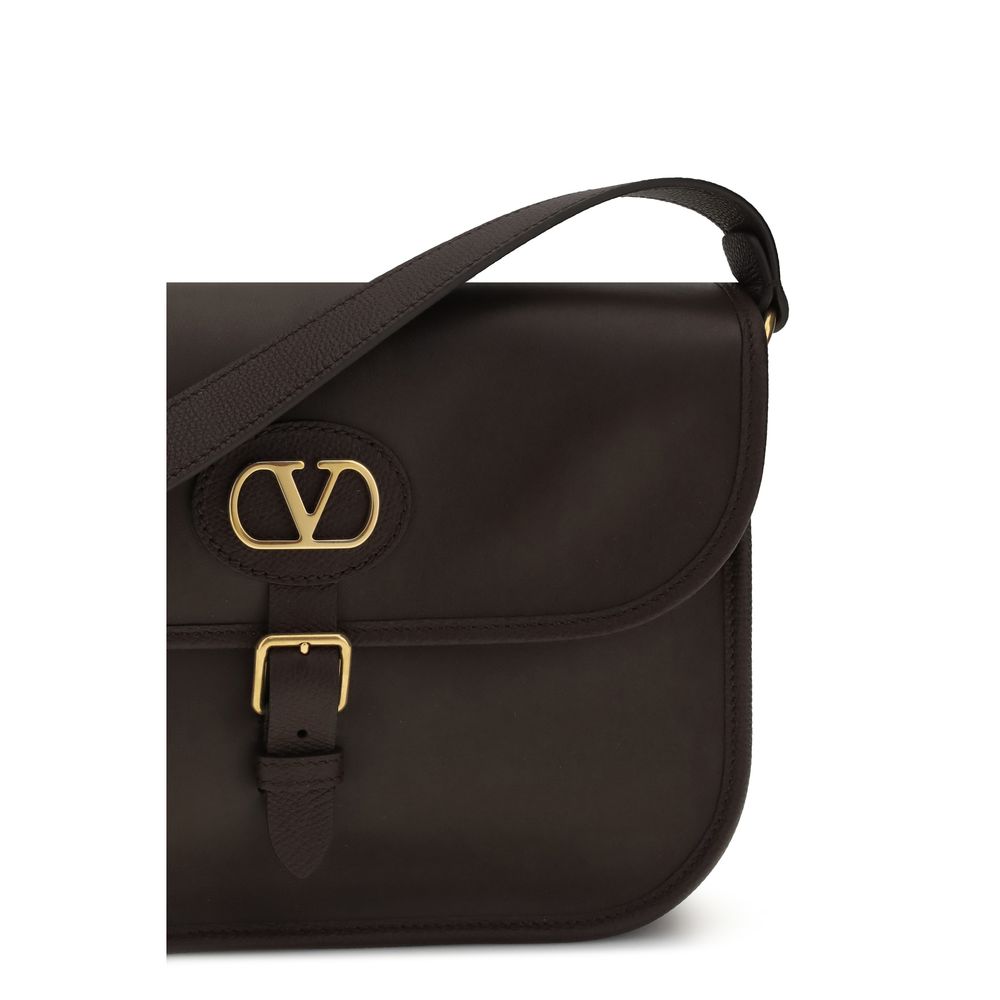 Shoulder Flap Bag by Valentino Garavani for men in bos taurus suede calfskin leather brown features a effortless chic silhouette with a secure flap, magnetic & button, ample cardholder, and versatile shoulder-strap & adjustable-strap for a effortless chic finish.