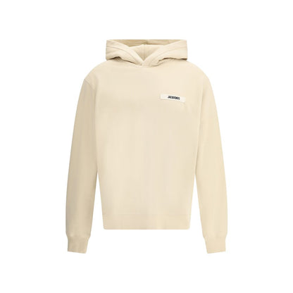 Sweatshirt Hoodie by Jacquemus for men in cotton beige & signature features an avant-garde silhouette, showcasing a sophisticated hooded neckline and detail for a truly avant-garde finish.