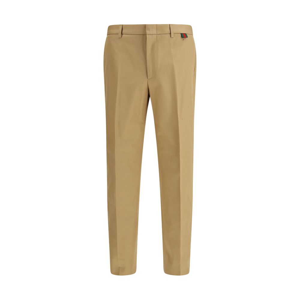 Trousers by Gucci for men in cotton beige presents a perennial silhouette, meticulously tailored with a regular-fit cut, long finish, and an elegant .