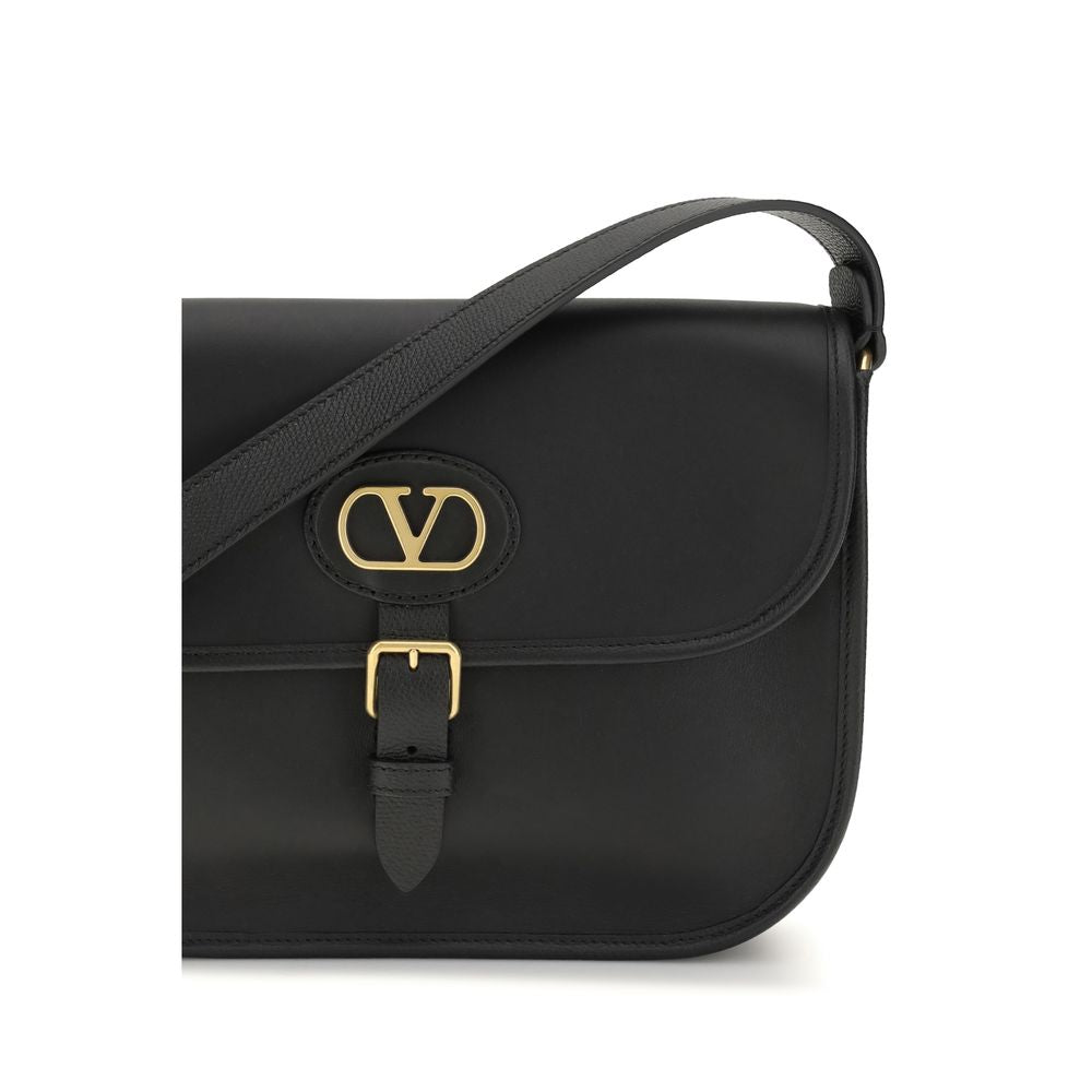 Shoulder Flap Bag by Valentino Garavani for men in bos taurus suede calfskin leather black features an effortlessly chic silhouette with a secure flap, magnetic & button, ample cardholder, and versatile shoulder-strap & adjustable-strap for effortlessly chic everyday luxury.