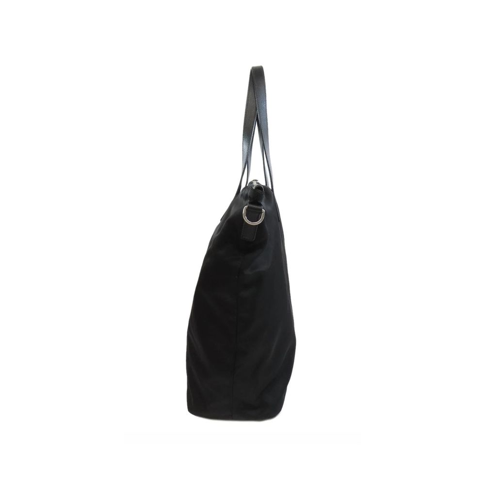 Tote Bag by Prada for women in nylon fabric black features a jet-set sophisticated Nylon Fabric Tote Bag design with a secure zipper, ample , and versatile shoulder-strap & handle for a jet-set sophisticated finish.