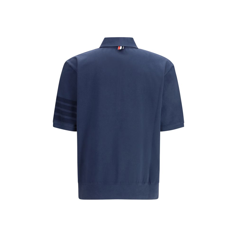 Polo Shirt by Thom Browne for men in cotton blue, signature & striped presents a distinguished silhouette, showcasing a sophisticated and distinguished for a truly distinguished finish.