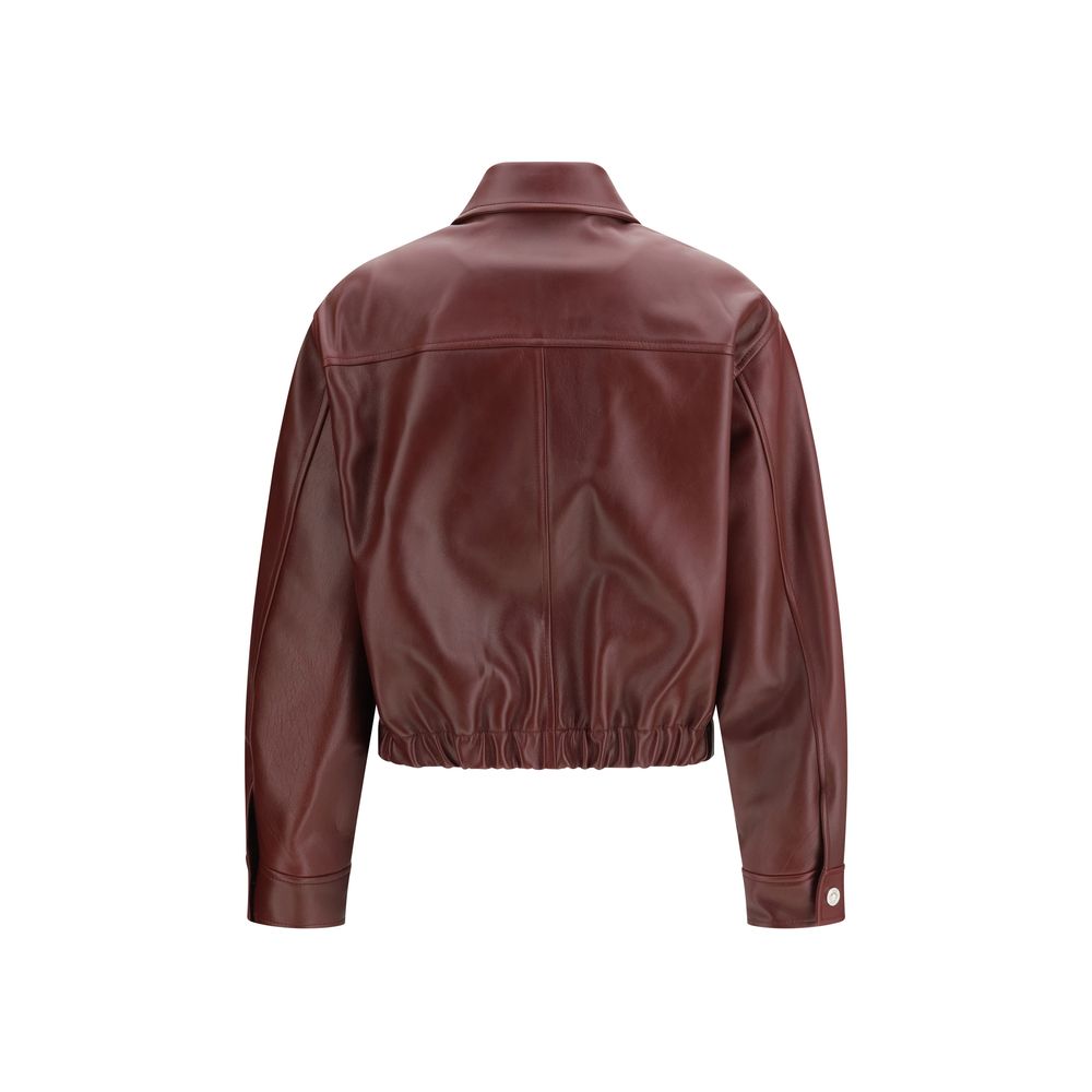 This Jacket by Versace for women in bos taurus calf leather bordeaux showcases a magnificent silhouette, meticulously crafted with a distinctive and functional pockets for a magnificent finish.
