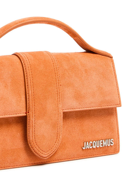 Small Crossbody Flap Handbag by Jacquemus for women in leather brown, gold & terracotta features a multifaceted silhouette, showcasing a secure flap & magnetic and multifaceted cardholder with versatile crossbody-strap, shoulder-strap, adjustable-strap & handle for multifaceted style.