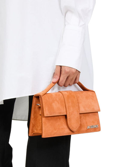 Small Crossbody Flap Handbag by Jacquemus for women in leather brown, gold & terracotta features an versatile silhouette, showcasing a secure flap & magnetic and versatile cardholder with versatile crossbody-strap, shoulder-strap, adjustable-strap & handle for a versatile finish.