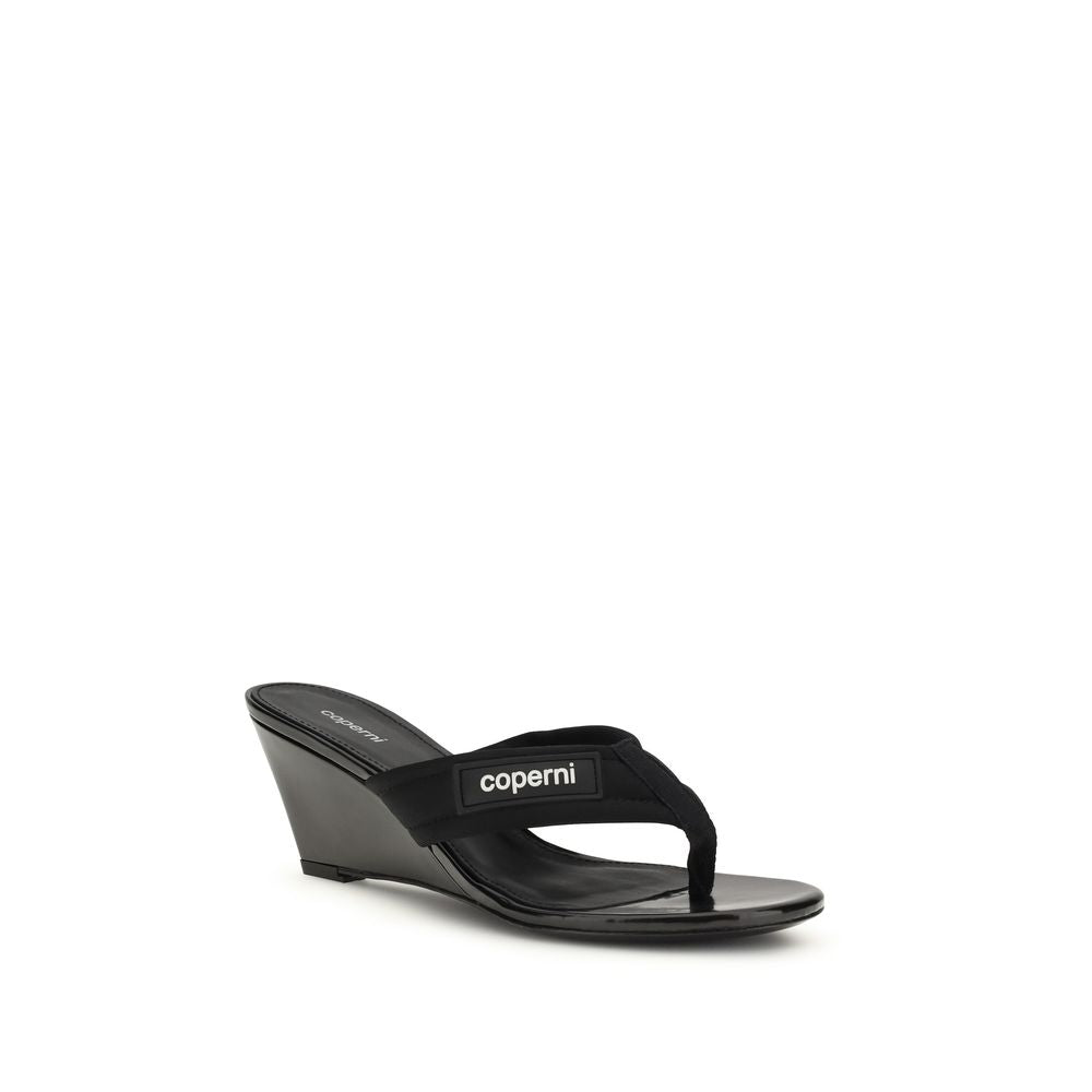 Wedge Flip-Flop Sandals by Coperni for women in polyamide black showcases a sculptural silhouette as Women's Polyamide Wedge Flip-Flop Sandals, defined by a sculptural wedge and sculptural for a sculptural look.