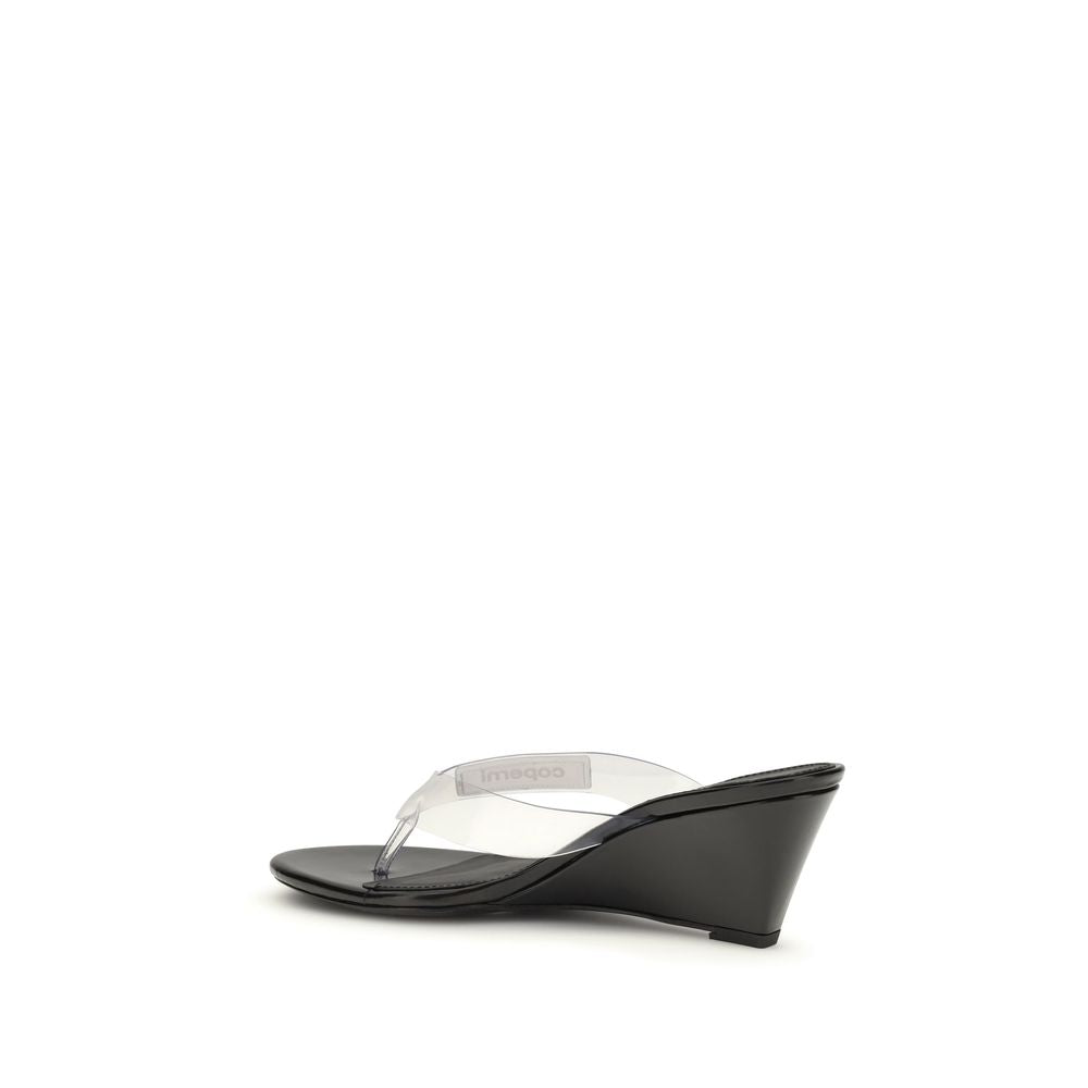 Wedge Flip-Flop Sandals by Coperni for women in pvc black & transparent presents a sculptural silhouette, showcasing the Women's PVC Wedge Flip-Flop Sandals design with a sculptural wedge and for a premium look.