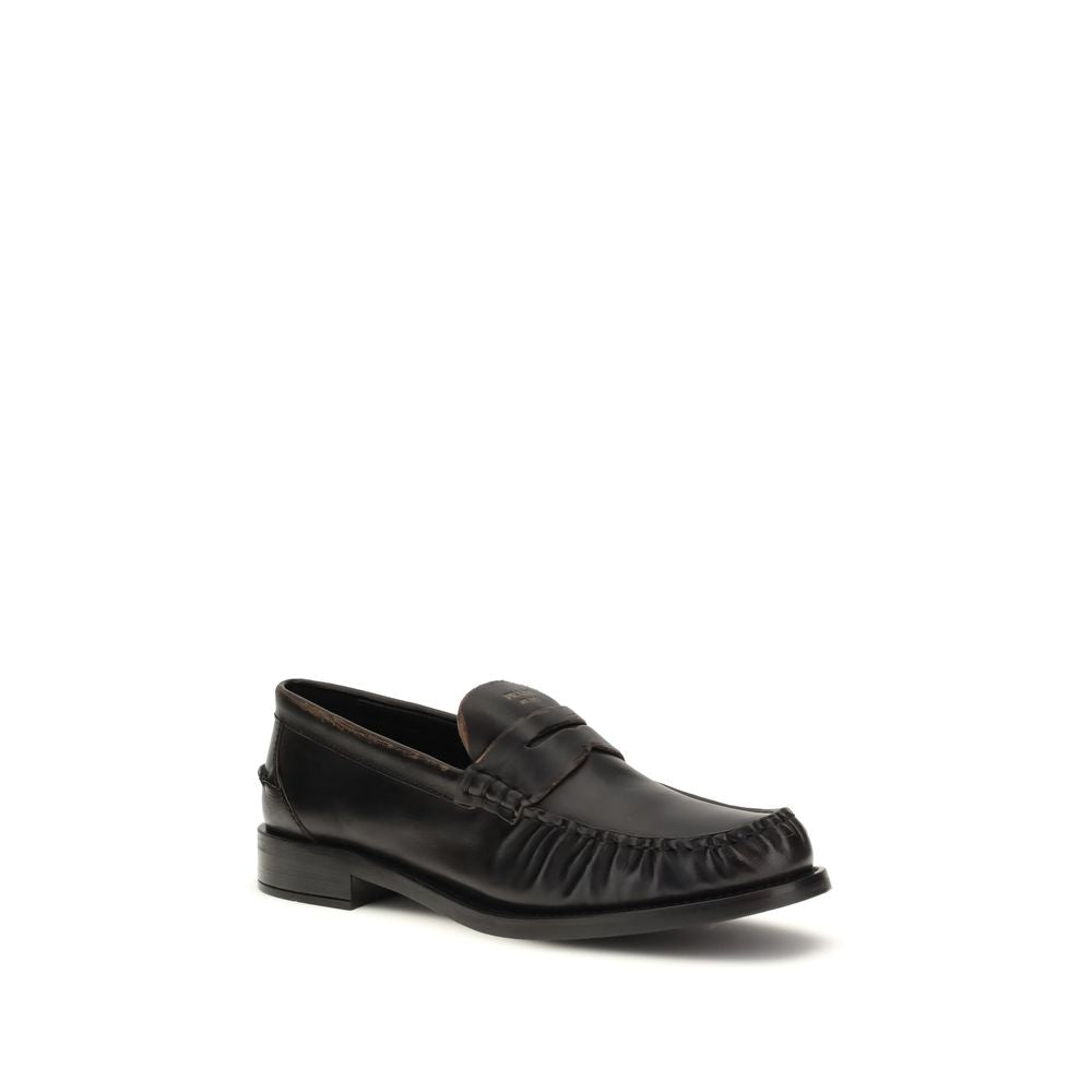 Flat Loafer Slip-On Shoes by Prada for women in bos taurus calf leather black showcases a resplendent Women's Bos Taurus Calf Leather Flat Loafer Slip-On Shoes aesthetic, defined by its resplendent round toe style and elegant flat.