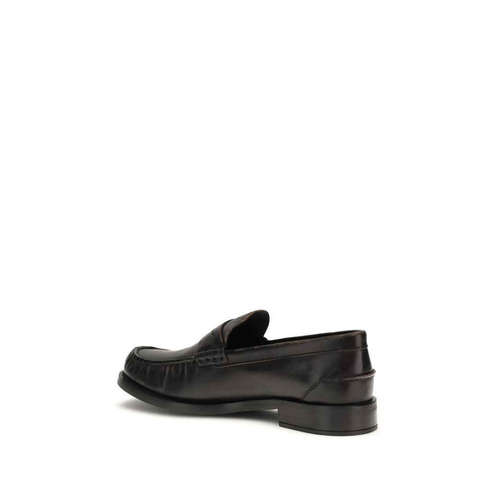 Flat Loafer Slip-On Shoes by Prada for women in bos taurus calf leather black showcases a timeless silhouette from the Women's Bos Taurus Calf Leather Flat Loafer Slip-On Shoes collection, featuring a timeless flat and round toe style for a timeless finish.