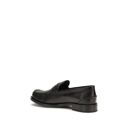 Flat Loafer Slip-On Shoes by Prada for women in bos taurus calf leather black showcases a timeless silhouette from the Women's Bos Taurus Calf Leather Flat Loafer Slip-On Shoes collection, featuring a timeless flat and round toe style for a timeless finish.