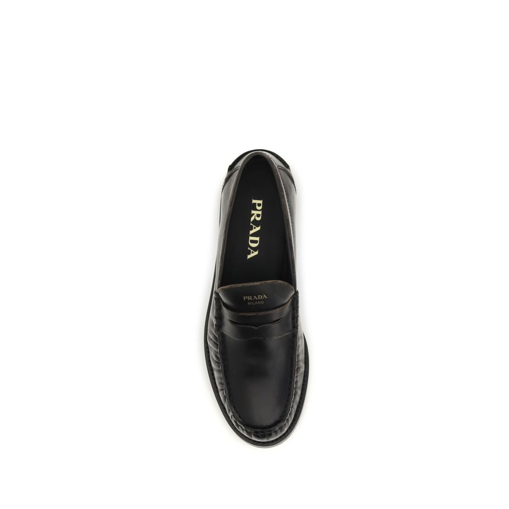 Flat Loafer Slip-On Shoes by Prada for women in bos taurus calf leather black features an dynamic silhouette from the Women's Bos Taurus Calf Leather Flat Loafer Slip-On Shoes collection, defined by a dynamic round toe style and flat for a dynamic look.
