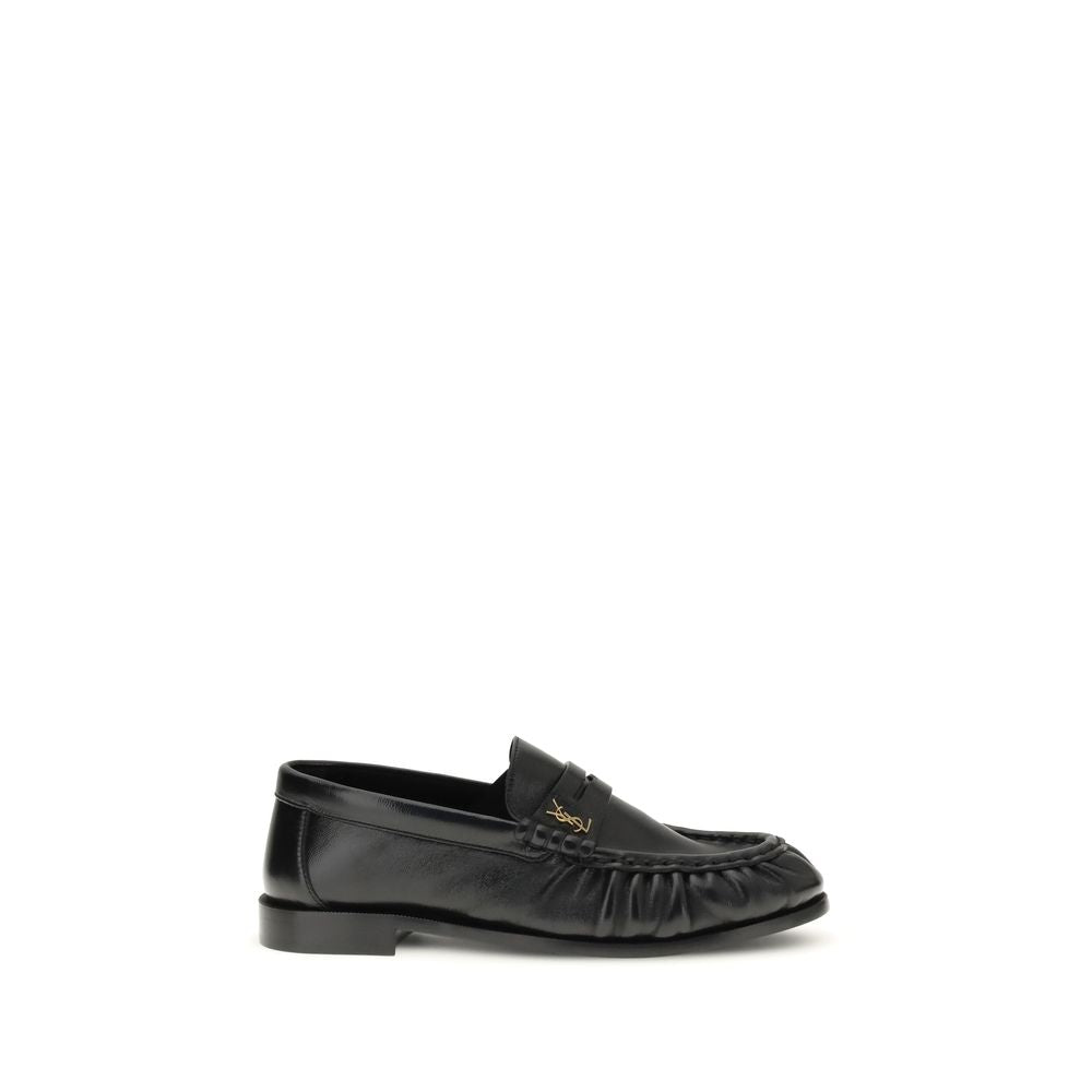 Flat Loafer Slip-On Shoes by Saint Laurent for women in leather & metal black, gold & signature showcases a resplendent Cassandre Women's Leather & Metal Flat Loafer Slip-On Shoes aesthetic, defined by its resplendent moc toe style and elegant flat.