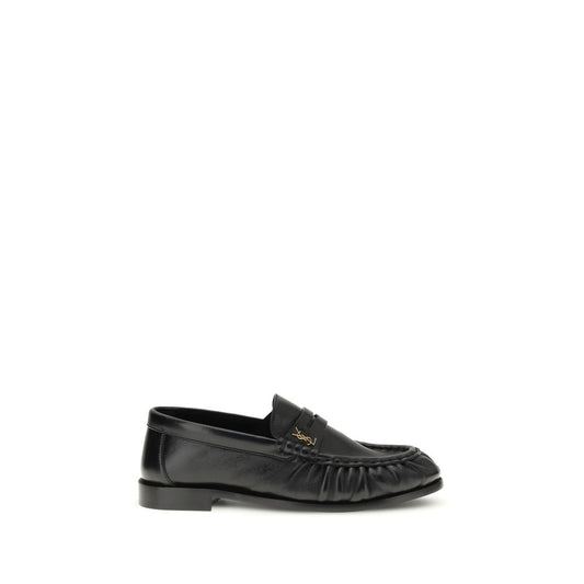 Flat Loafer Slip-On Shoes by Saint Laurent for women in leather & metal black, gold & signature showcases a resplendent Cassandre Women's Leather & Metal Flat Loafer Slip-On Shoes aesthetic, defined by its resplendent moc toe style and elegant flat.