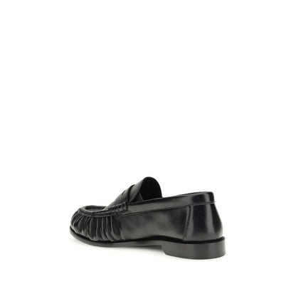 Flat Loafer Slip-On Shoes by Saint Laurent for women in leather & metal black, gold & signature features an effortless chic silhouette, showcasing the Cassandre Women's Leather & Metal Flat Loafer Slip-On Shoes design with an effortless chic flat and a moc toe style for a effortless chic look.