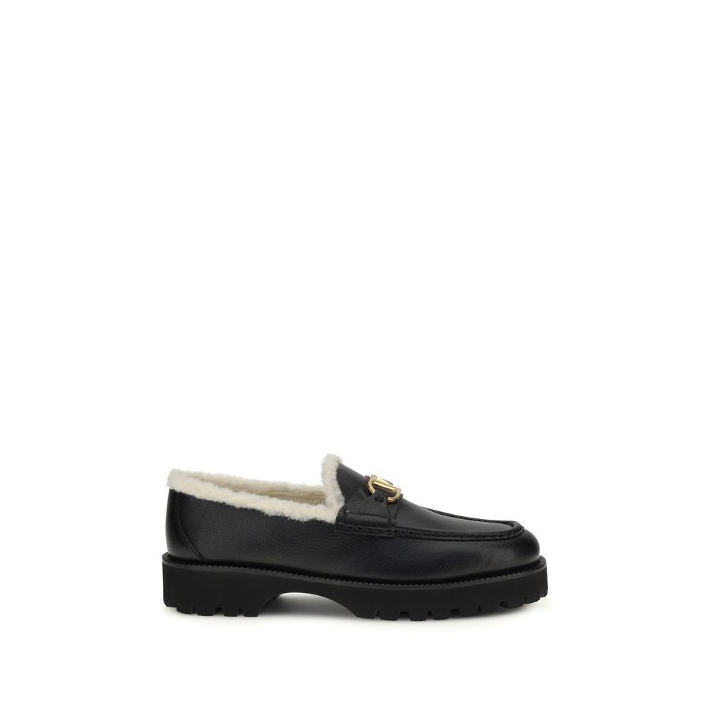 Flat Loafer Slip-On Shoes by Valentino Garavani for women in bost taurus calf leather & fur black showcases a resplendent V Logo Women's Bost Taurus Calf Leather & Fur Flat Loafer Slip-On Shoes aesthetic, defined by its resplendent round toe style and elegant flat.