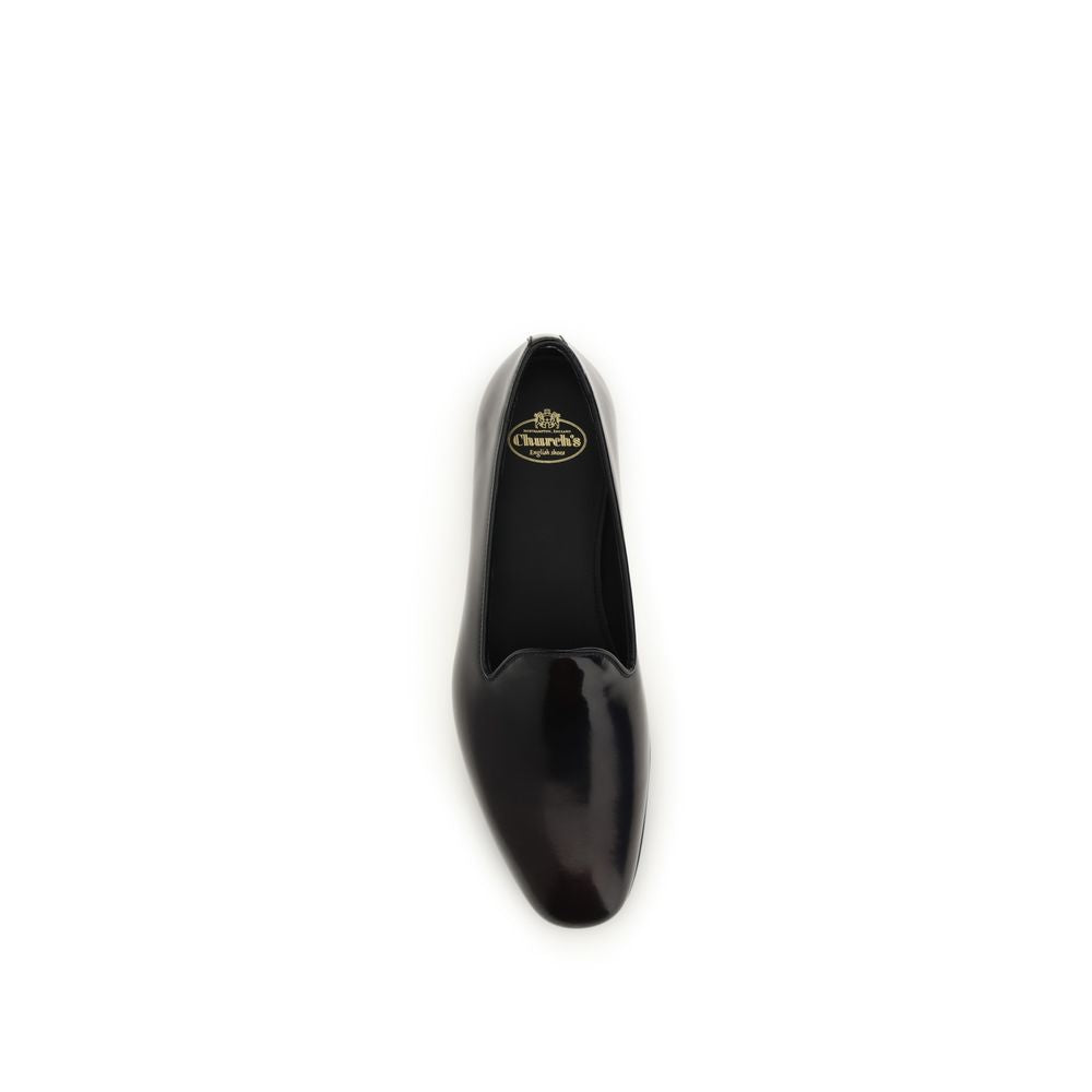 Flat Loafer Slip-On Shoes by Church's for women in bos taurus calf leather black features an effortless chic silhouette, showcasing the Women's Bos Taurus Calf Leather Flat Loafer Slip-On Shoes design with an effortless chic flat and a round toe style for a effortless chic look.