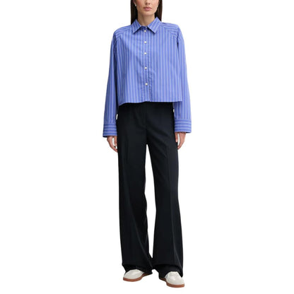 Shirt by Calvin Klein Jeans for women in cotton blue presents a discerning silhouette, showcasing a sophisticated and for a truly discerning finish.