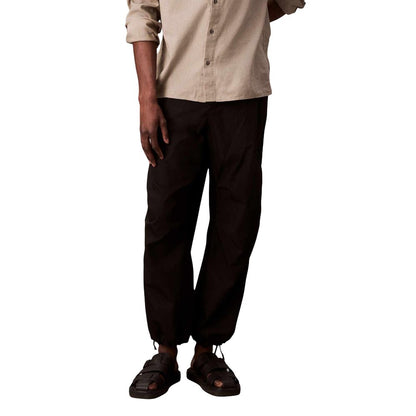 Activewear Jogger Pants by Calvin Klein Jeans for men in nylon cotton black features a contemporary silhouette with breathable-design, a contemporary , long hem, and for a premium, high-performance aesthetic.