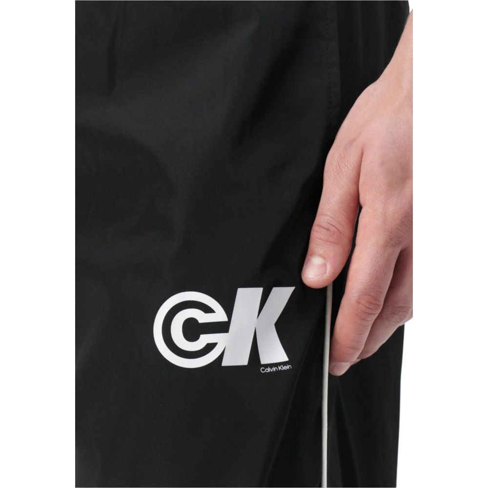 Activewear Jogger Pants by Calvin Klein Jeans for men in poly nylon fabric black features an dynamic regular-fit with long, , and functional for an dynamic silhouette.