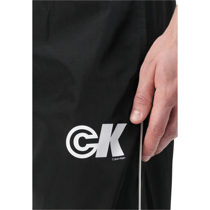 Activewear Jogger Pants by Calvin Klein Jeans for men in poly nylon fabric black features an dynamic regular-fit with long, , and functional for an dynamic silhouette.