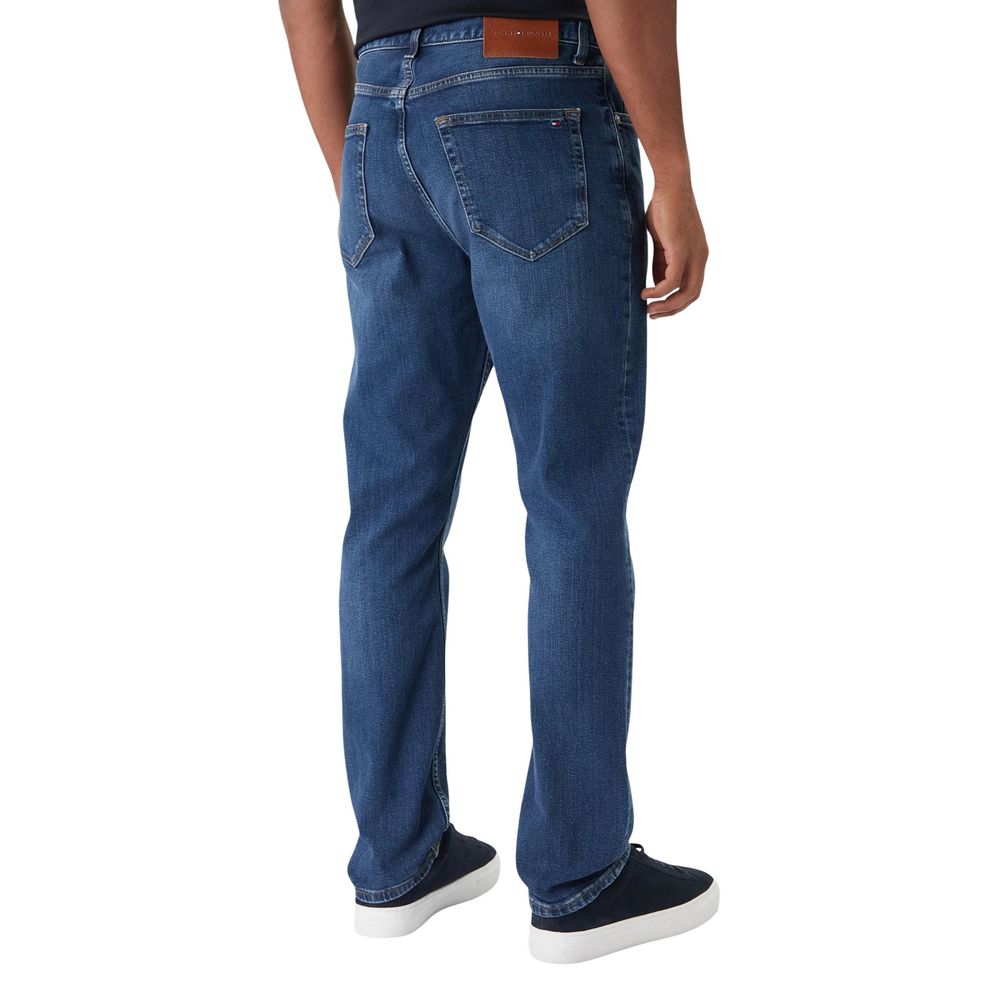 Jeans by Tommy Hilfiger for men in stretch denim cotton blue presents a refined pantology silhouette, artfully defined by a refined pantology straight-leg, relaxed-fit & regular-fit, long, and a sophisticated .