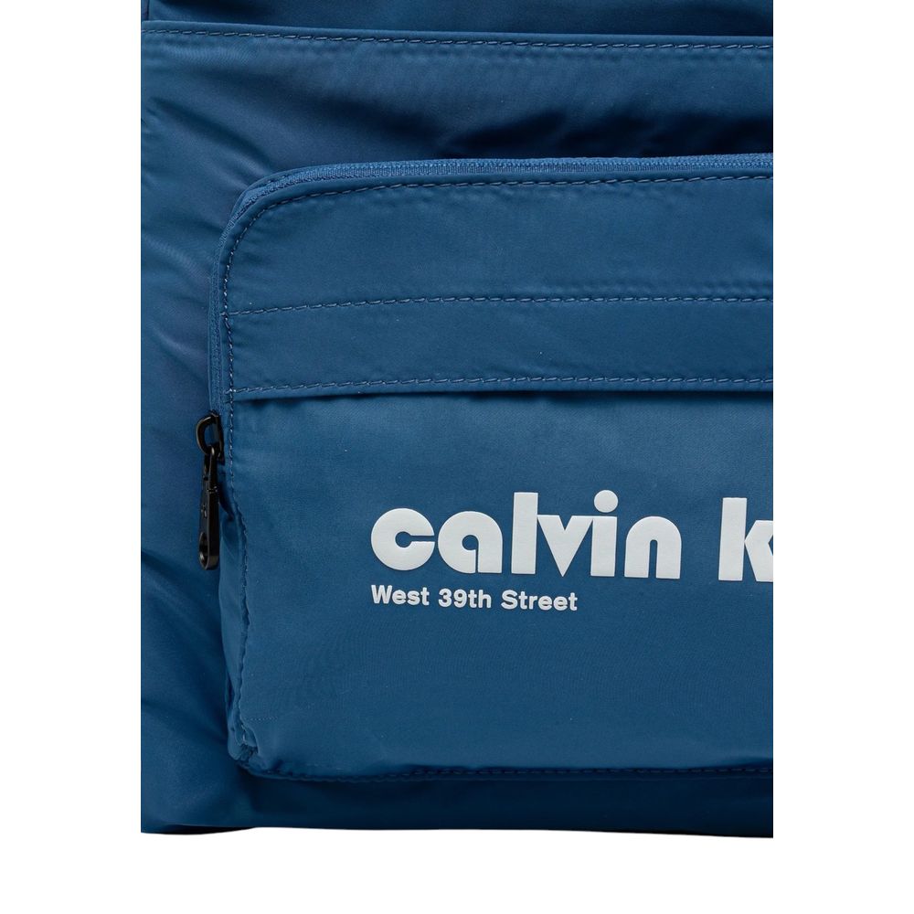 Compact Backpack by Calvin Klein for men in polyester blue, signature & print features an stately silhouette from the Polyester Compact Backpack range, with a secure zipper, ample external-pockets & laptop-compartment, and versatile handle, backpack-strap & adjustable-strap.
