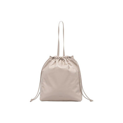 Large Tote Handbag by Calvin Klein for women in polyethylene & polyurethane beige features a signature silhouette, showcasing a secure drawstring and signature with versatile handle for a sophisticated look.