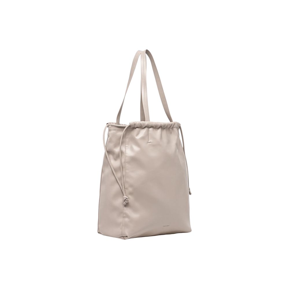Large Tote Handbag by Calvin Klein for women in polyethylene & polyurethane beige features a exquisite silhouette, showcasing a secure drawstring and exquisite with versatile handle for a exquisite finish.