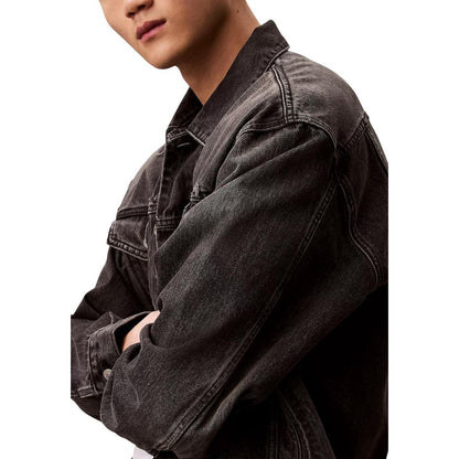 Jacket by Calvin Klein Jeans for men in denim cotton black features an utilitarian silhouette with a refined shirt-collar neckline, showcasing sophisticated pockets for an utilitarian aesthetic.