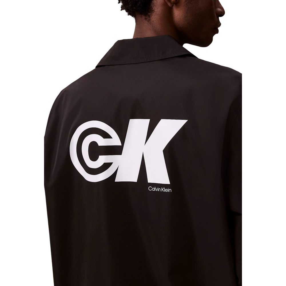 Windbreaker Jacket by Calvin Klein Jeans for men in nylon & polyester black presents a resilient silhouette, artfully detailed with a sophisticated and functional windproof for a resilient finish.