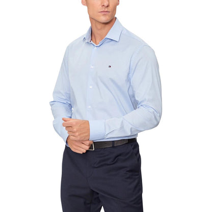 Shirt by Tommy Hilfiger for men in stretch organic cotton blue showcases a sharp silhouette, elegantly detailed with a sharp and sharp .