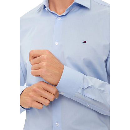Shirt by Tommy Hilfiger for men in stretch organic cotton blue showcases a sharp silhouette, elegantly detailed with a sharp and sharp .