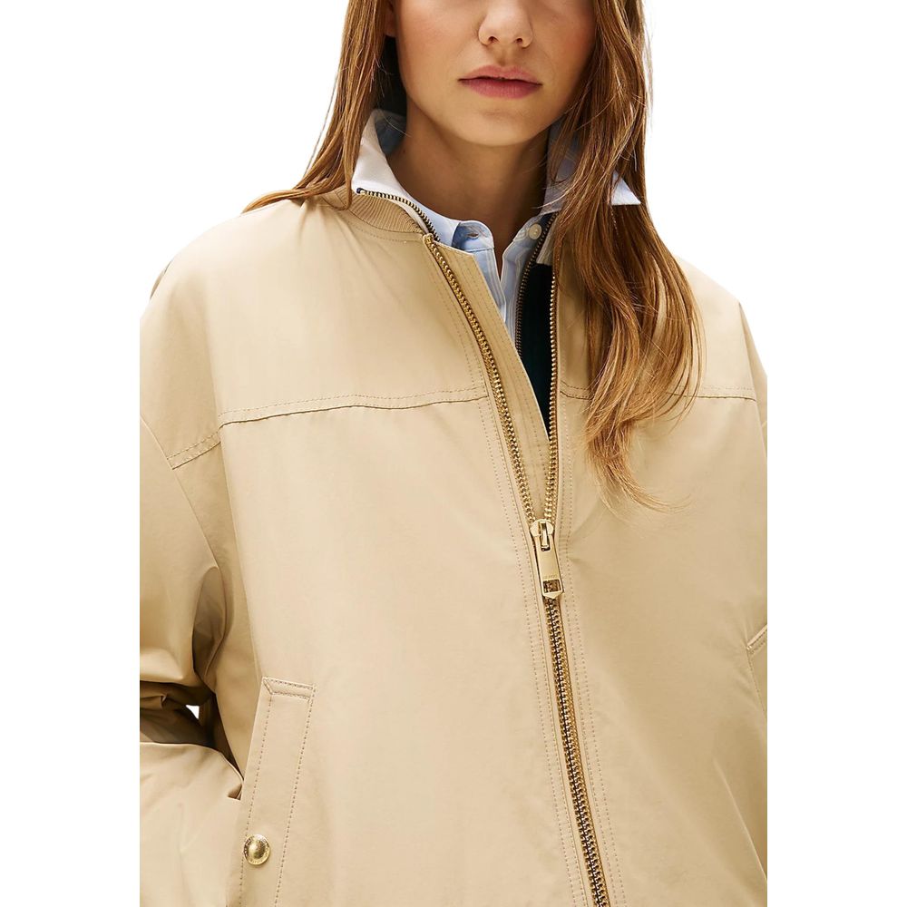 Bomber Jacket by Tommy Hilfiger for women in cotton & nylon beige & gold showcases a bohemian silhouette, artfully detailed with a bohemian and signature pockets for a truly bohemian finish.