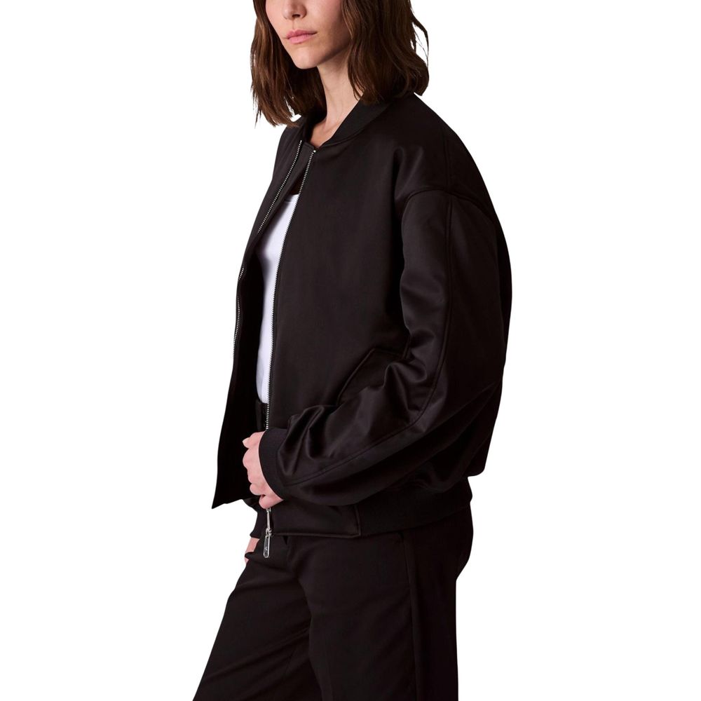 Bomber Jacket by Calvin Klein Jeans for women in polyester satin black showcases a bohemian silhouette, artfully detailed with a bohemian and signature for a truly bohemian finish.