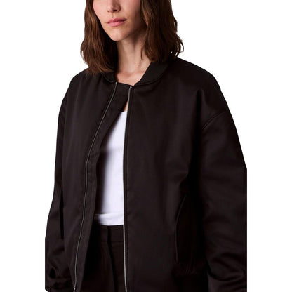 Bomber Jacket by Calvin Klein Jeans for women in polyester satin black features a city-ready silhouette, detailed with and a city-ready .