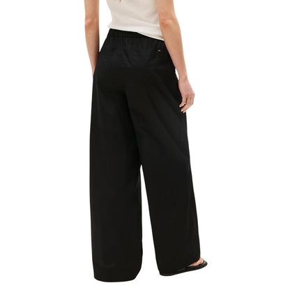 Trousers by Tommy Hilfiger for women in organic cotton black presents a smart silhouette, meticulously detailed with a smart flared, bootcut, relaxed-fit & wide, a smart long, and a smart .