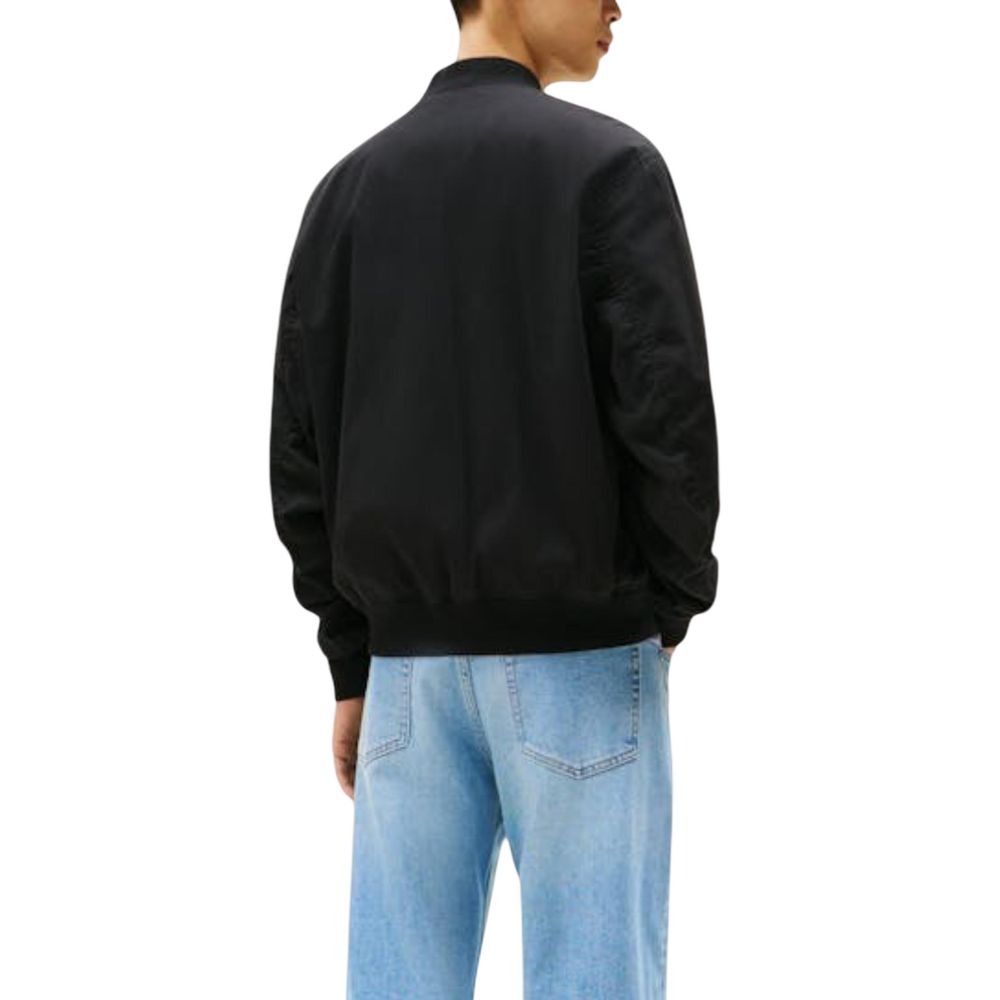 Bomber Jacket by Tommy Hilfiger Jeans for men in polyamide cotton black features an contemporary silhouette, showcasing a sophisticated and contemporary pockets for a truly refined look.