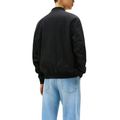 Bomber Jacket by Tommy Hilfiger Jeans for men in polyamide cotton black features an contemporary silhouette, showcasing a sophisticated and contemporary pockets for a truly refined look.