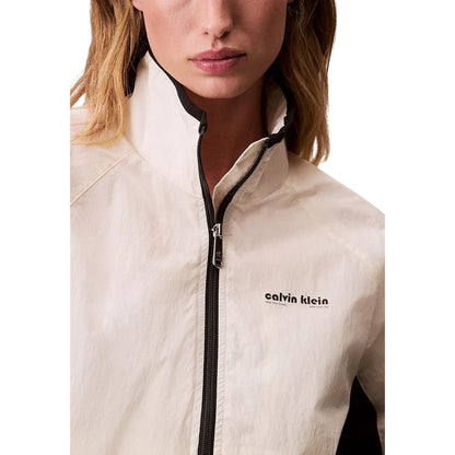 Windbreaker Jacket by Calvin Klein Jeans for women in polypropylene white presents a resilient silhouette, artfully detailed with a sophisticated high-collar neckline and functional lightweight & windproof for a resilient finish.