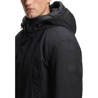 Hooded Trench Coat by Hugo Boss for men in polyester black presents an sculptural silhouette, artfully detailed with a sculptural hooded neckline and functional pockets & hooded for a truly sculptural finish.