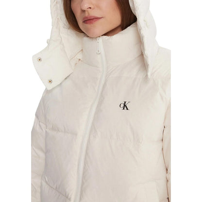 Hooded Overcoat by Calvin Klein Jeans for women in polyamide cream features an voluminous silhouette, showcasing distinct lightweight, hooded & insulated and a voluminous for a truly voluminous aesthetic.