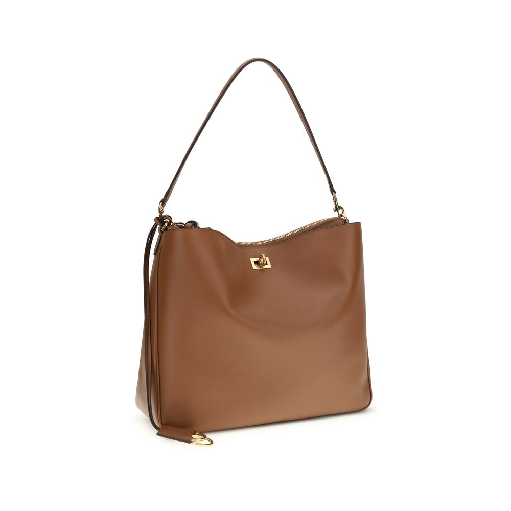 Large Shoulder Bag by Balenciaga for women in bos taurus calf leather beige & gold presents a versatile silhouette, showcasing a secure zipper & turn-lock and versatile external-pockets with versatile shoulder-strap & handle for a sophisticated look.