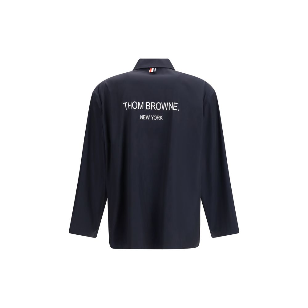 Overcoat by Thom Browne for men in polyester blue, signature & print features an voluminous silhouette, showcasing distinct lightweight & pockets and a voluminous for a truly voluminous aesthetic.