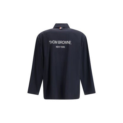 Overcoat by Thom Browne for men in polyester blue, signature & print features an voluminous silhouette, showcasing distinct lightweight & pockets and a voluminous for a truly voluminous aesthetic.