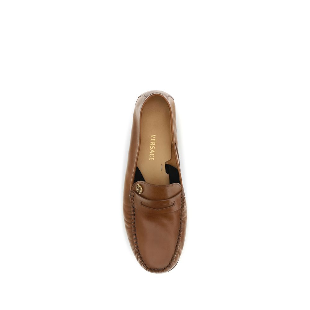 Loafer Slip-On Shoes by Versace for men in bos taurus calf leather brown features an effortless chic silhouette, showcasing the Medusa Men's Bos Taurus Calf Leather Loafer Slip-On Shoes design with an effortless chic and a for a effortless chic look.